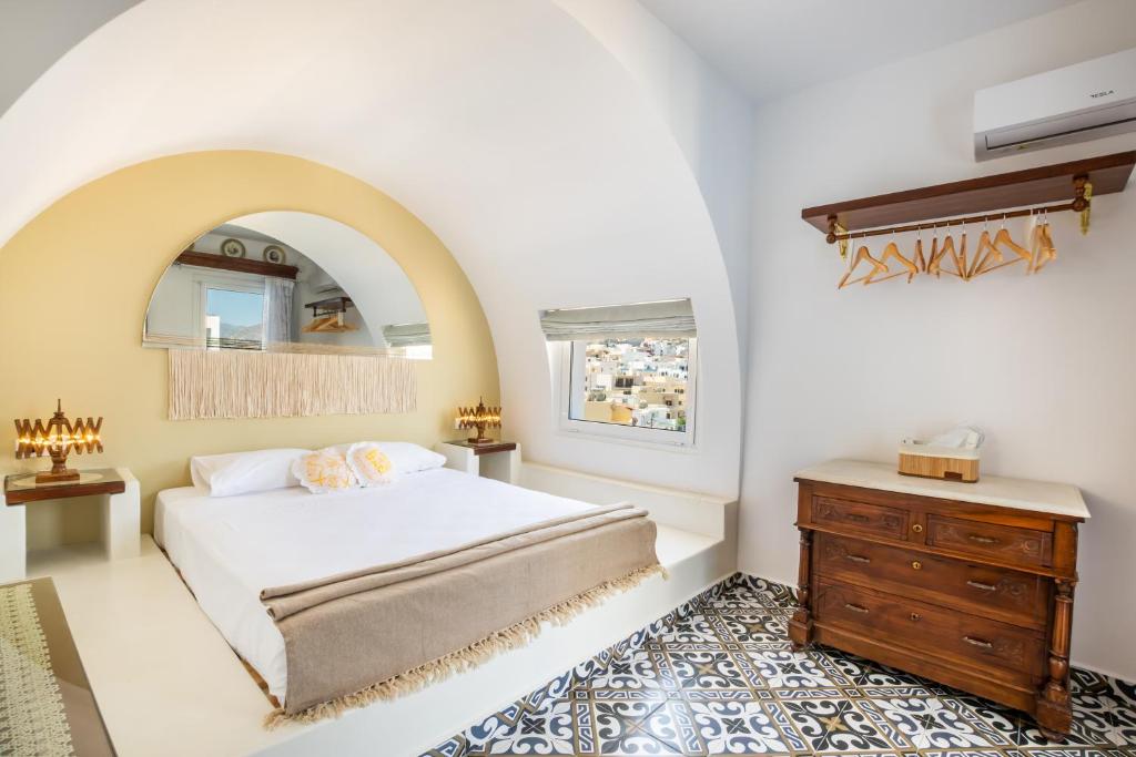 a bedroom with a bed and a wooden dresser at Gorgona Traditional 3 in Karpathos Town