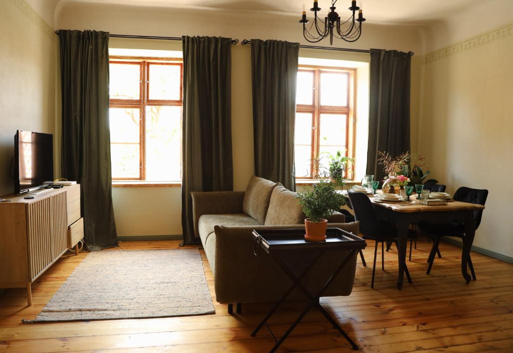 a living room with a couch and a table at K&L Old Town Kuldīga in Kuldīga