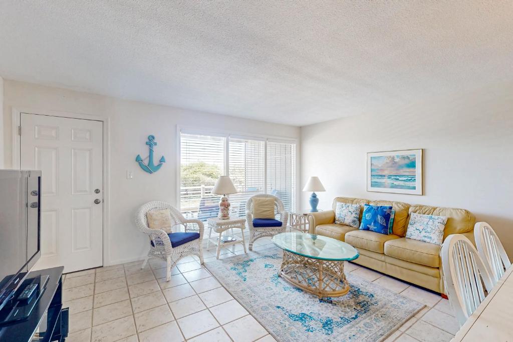 a living room with a couch and a table at Tar Landing Villas 306 in Atlantic Beach