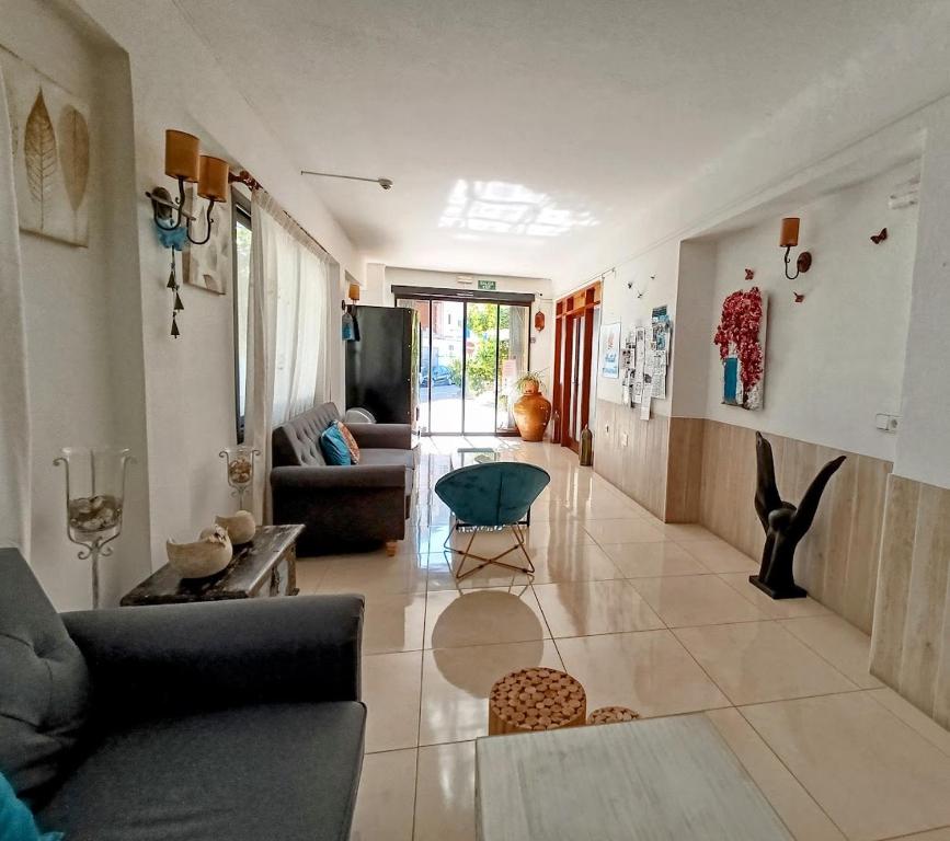 a living room with a couch and a table at Hostal Horizonte in San Antonio