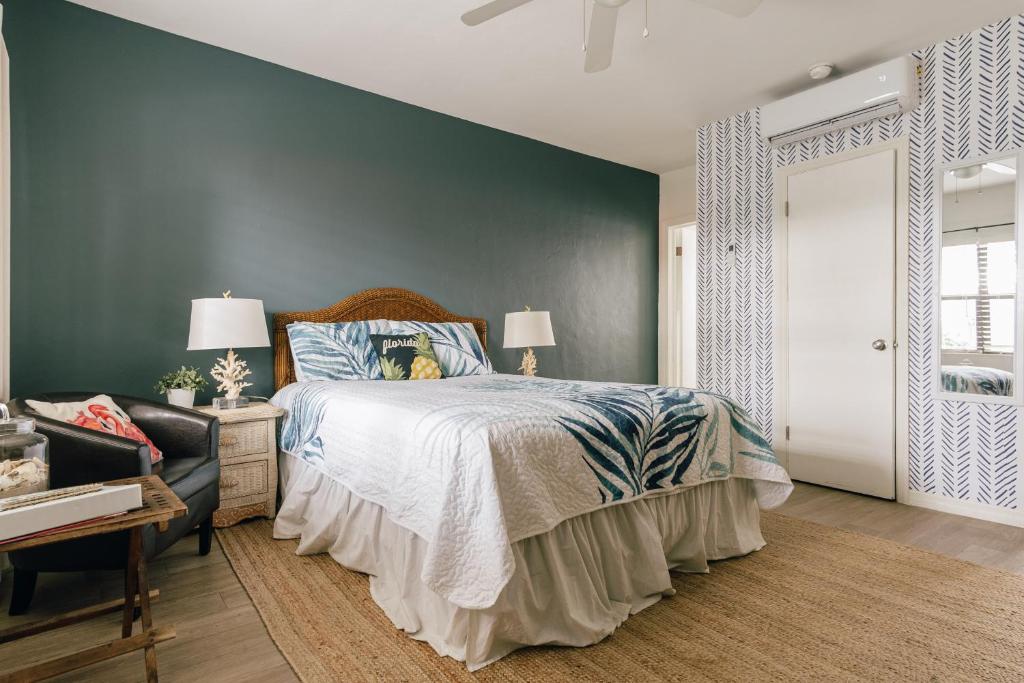 a bedroom with a bed and a blue wall at Private Studio Walk to Beach -- Apartment 2 in Pompano Beach