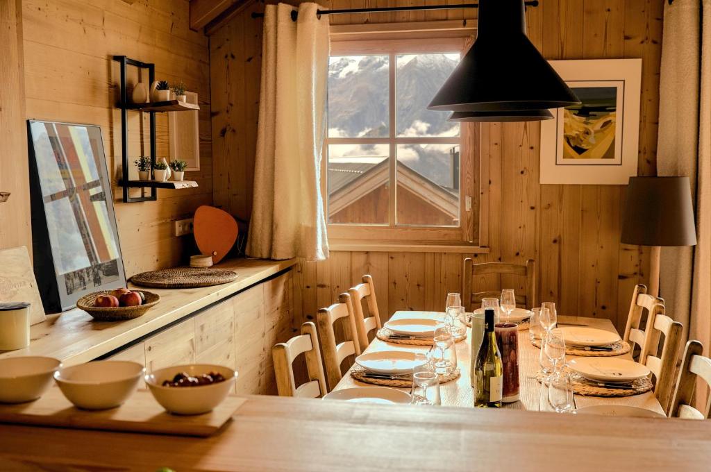 une salle à manger avec une grande table et une fenêtre dans l'établissement Blanc Marine, à Villard-Reculas