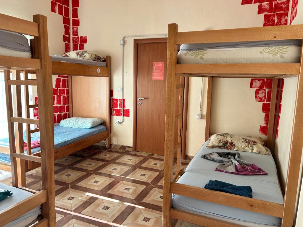 a room with two bunk beds and a hallway at D1 Hostel in Tirana