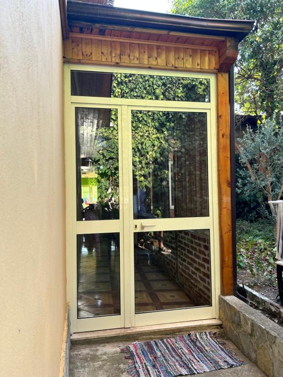 a large glass door on the side of a house at D1 Hostel in Tirana