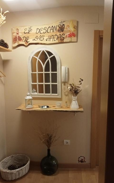 a bathroom with a sink and a mirror at El descanso de las hadas in San Leonardo de Yagüe
