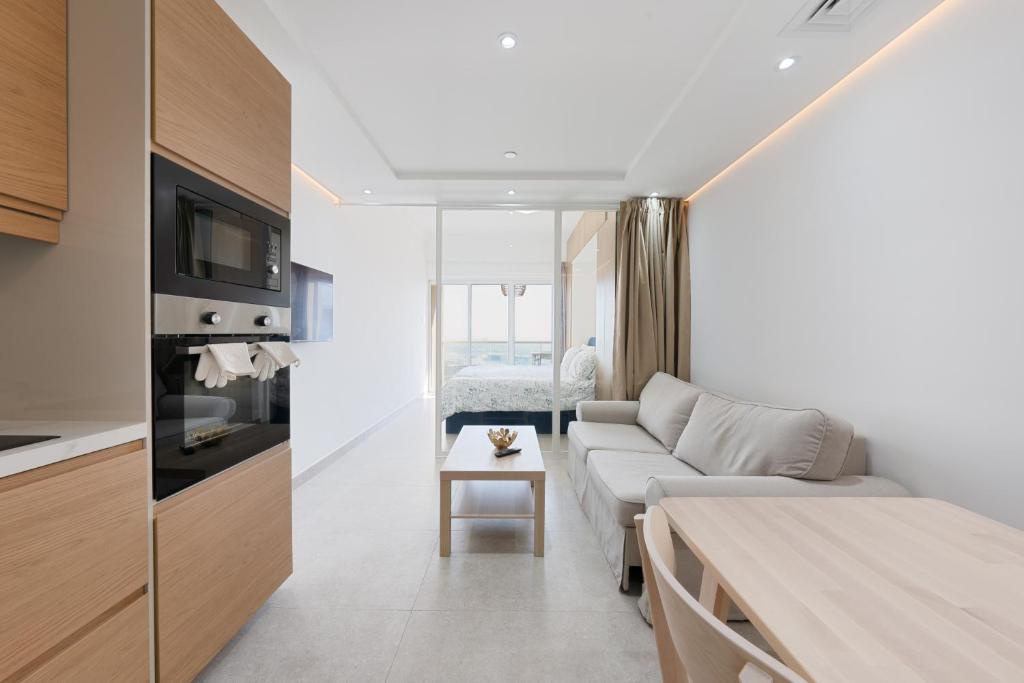 a living room with a couch and a table at What a view - very close to DMCC metro station in Dubai