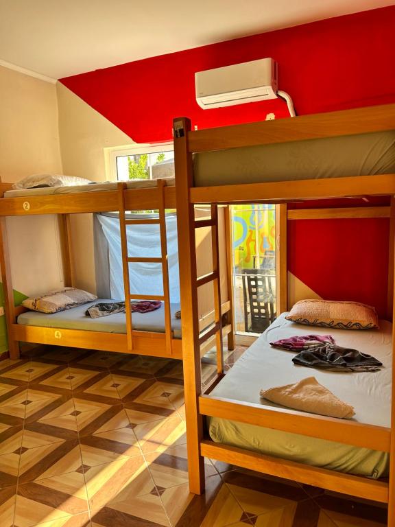 two bunk beds in a room with a red ceiling at D1 Hostel in Tirana