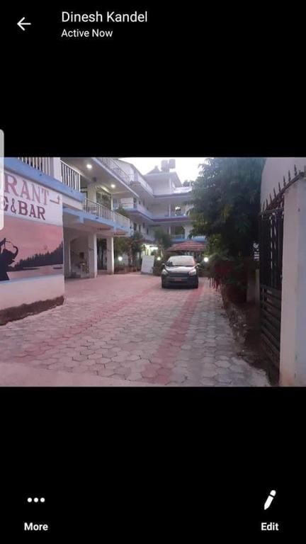 a car parked on a brick road in front of buildings at Hotel Shiva's Dream in Sauraha
