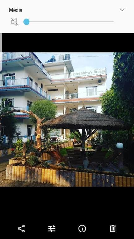 a large umbrella in front of a building at Hotel Shiva's Dream in Sauraha