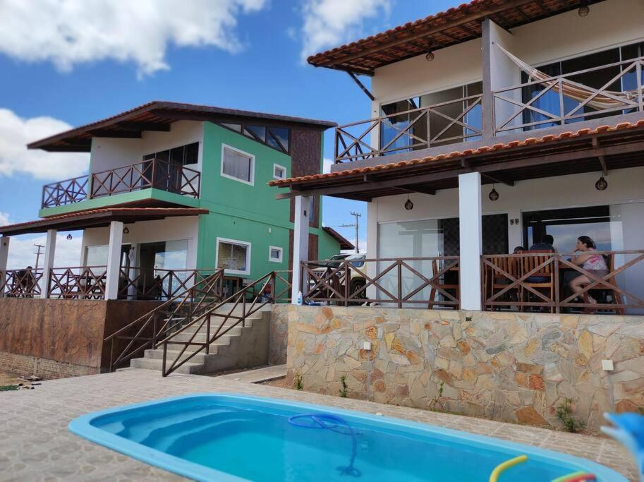 eine Villa mit einem Swimmingpool vor einem Haus in der Unterkunft Refúgio da Serra Gameleiras in Monte das Gameleiras