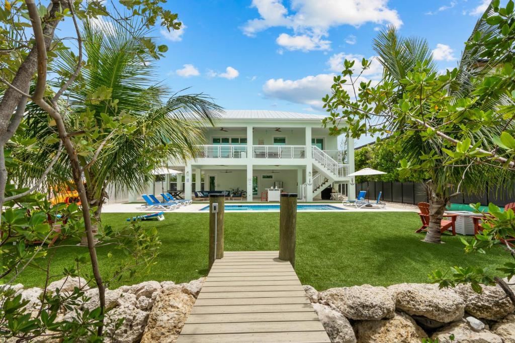 a view of the house from the backyard at Emerald Oasis Deluxe Waterfront Gem, Heated Pool with Dock in Marathon