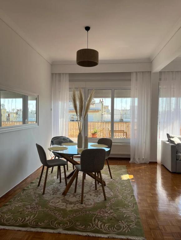 a dining table and chairs in a living room at SKG City Center Apartment in Thessaloniki
