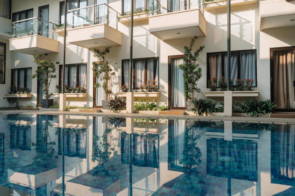 a swimming pool in front of a building at Anugrah Hotel Sukabumi in Sukabumi
