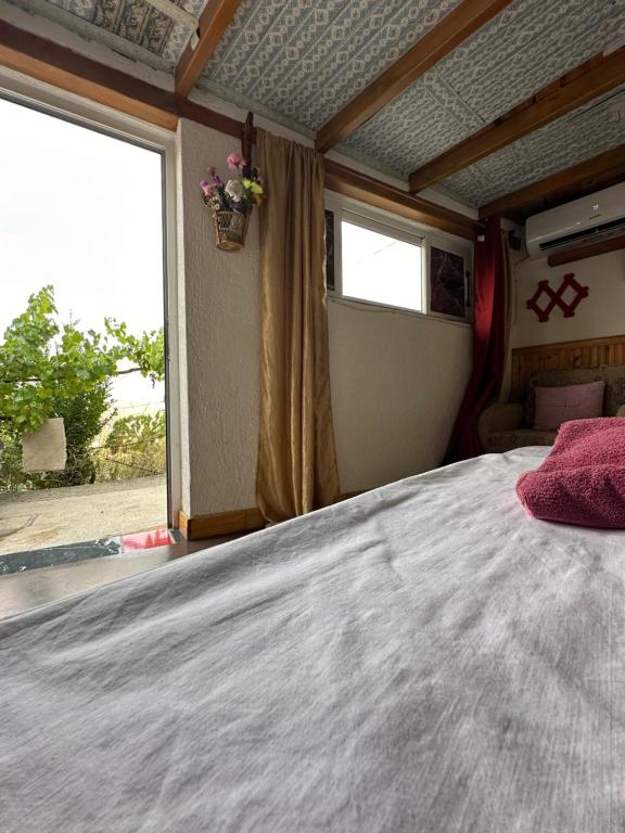 a bedroom with a large bed and a window at Villa Zeko in Gjirokastër