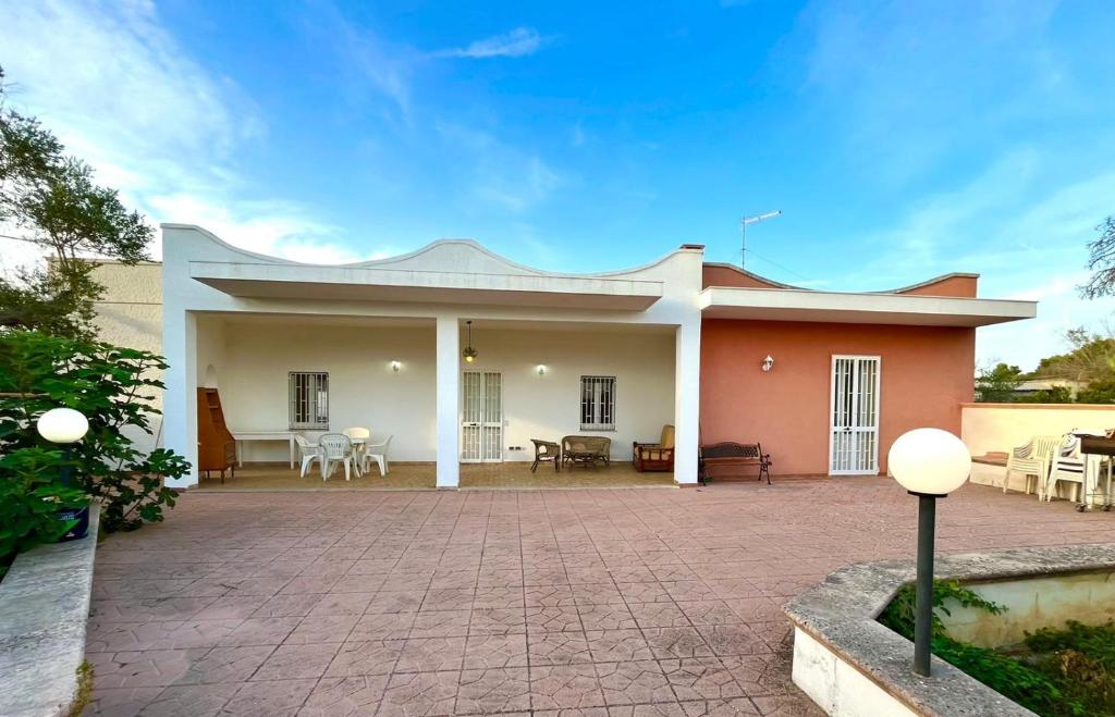 a house with a brick patio in front of it at Villa Immacolata in Monteroni di Lecce
