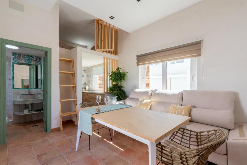 a living room with a couch and a table at Apartamento Isaac Peral 3 in Chipiona