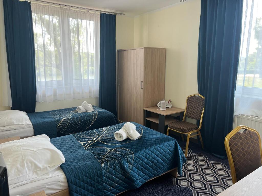 Łóżko lub łóżka w pokoju w obiekcie Hotel Vistula
