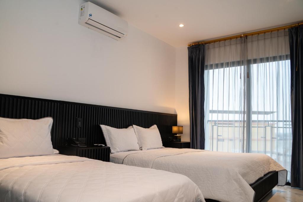 Postel nebo postele na pokoji v ubytování Manta Surf Hotel