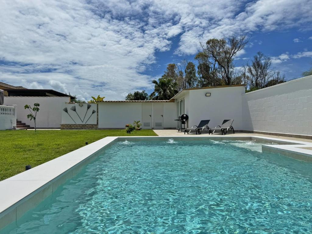 a swimming pool in the backyard of a house at Villa Victoria - Ole Solutions in El Puerto de Santa María