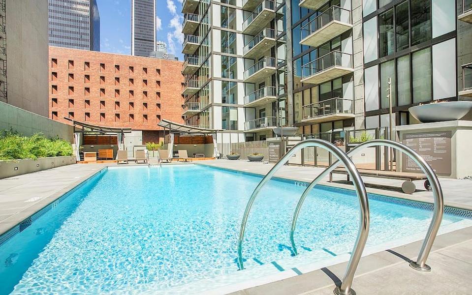 Hotel 2 Bed 2 Bath X street LA Live, Convention Center, Microsoft Theater, a large swimming pool in the middle of a building at 2 Bed 2 Bath X street LA Live, Convention Center, Microsoft Theater in Los Angeles