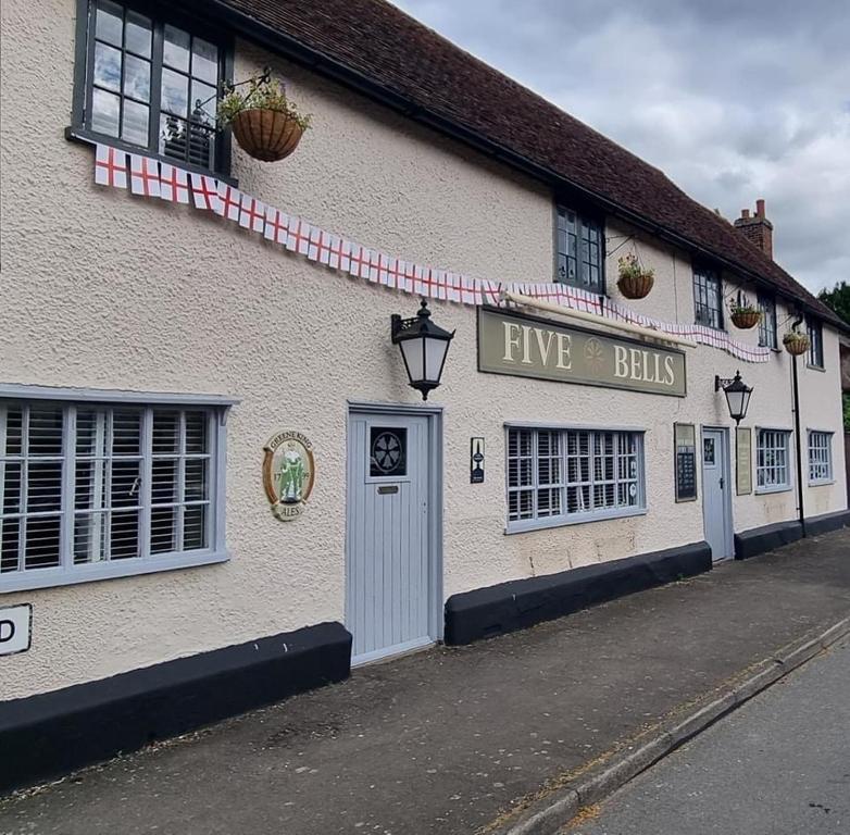 a building with a sign that says five bills at The Five Bells in Cople