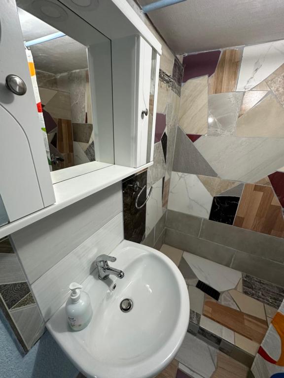 a bathroom with a sink and a mirror at Villa Zeko in Gjirokastër