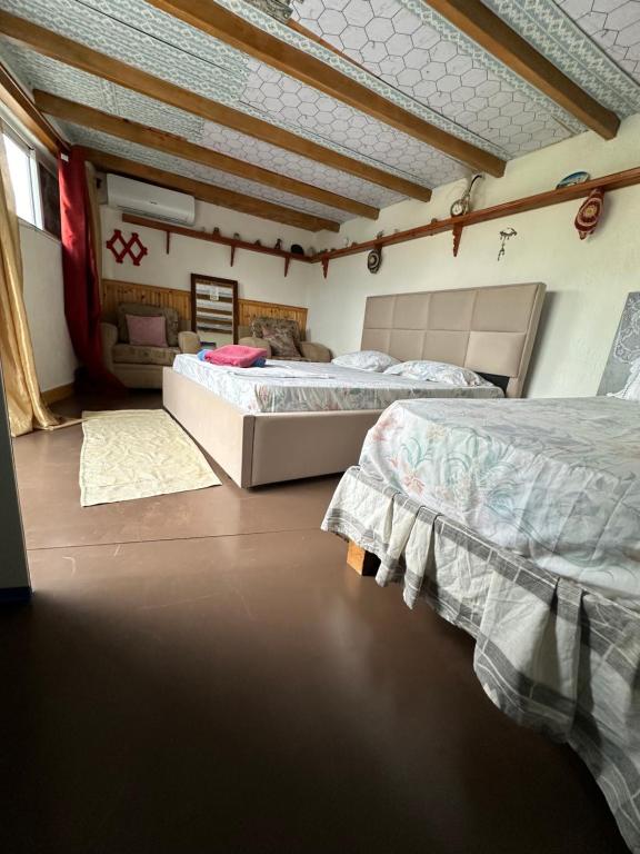 a bedroom with two beds in a room at Villa Zeko in Gjirokastër