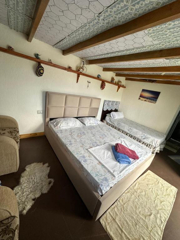 a bedroom with a large bed in a room at Villa Zeko in Gjirokastër