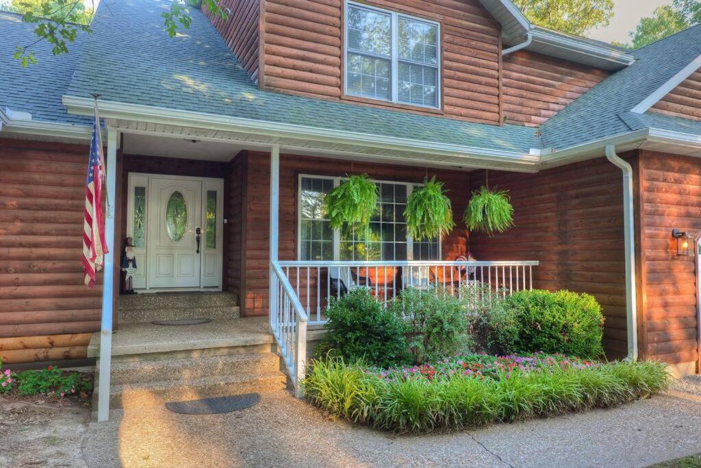a house with an american flag in front of it at Rural 6 bedroom cabin - With a Hot Tub! in Exeter