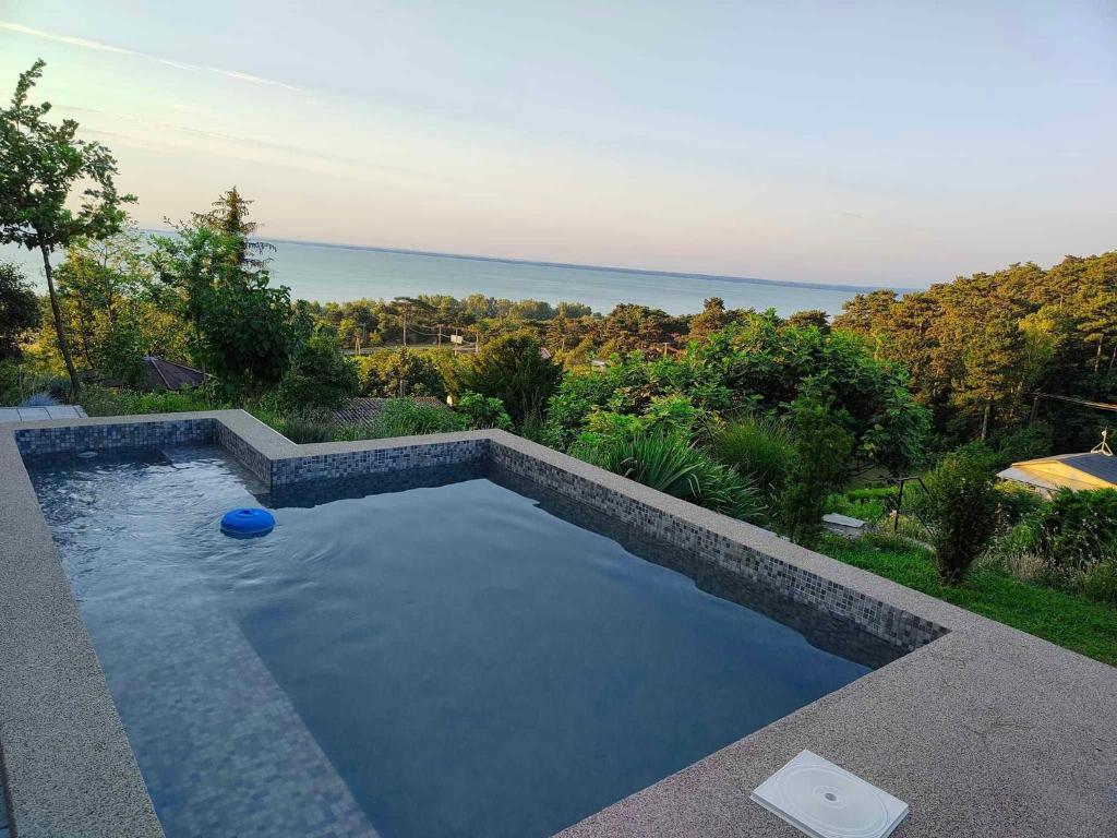 a swimming pool with a view of the ocean at Holiday home in Balatongyörök 43114 in Balatongyörök
