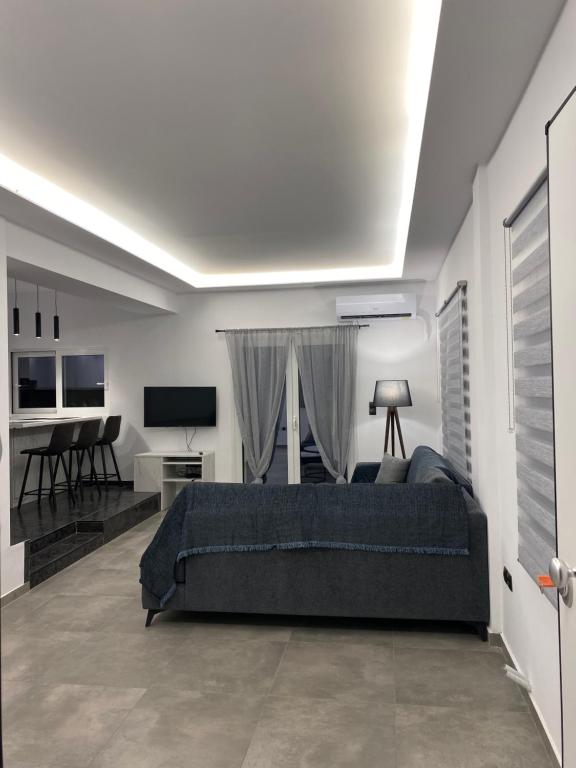 a bedroom with a bed and a living room at Anafis Exclusive in Athens