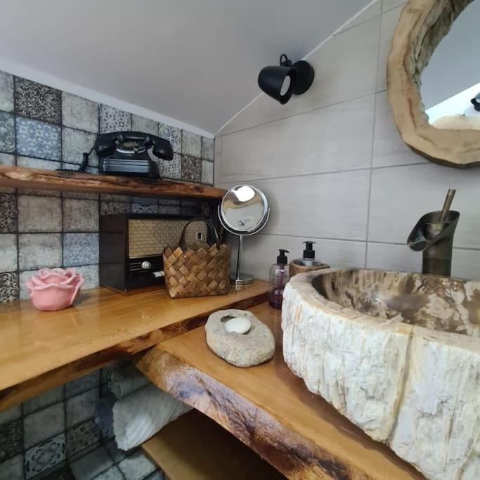 a bathroom with a sink and a large tub at Mansarda boema, gradina de basm in Bucharest