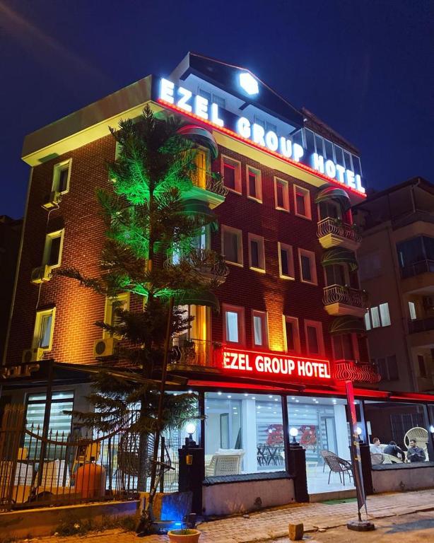 a building with a neon sign on top of it at Ezel Group Hotel in Antalya
