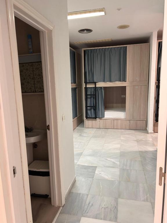 a room with a bathroom with a toilet and a sink at Hostel Sorolla Playa in Málaga