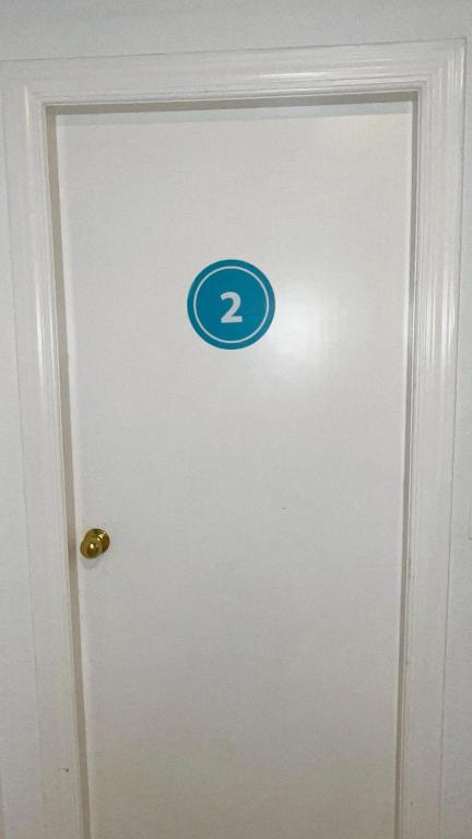 a door with a number sign on it at Hostel Sorolla Playa in Málaga