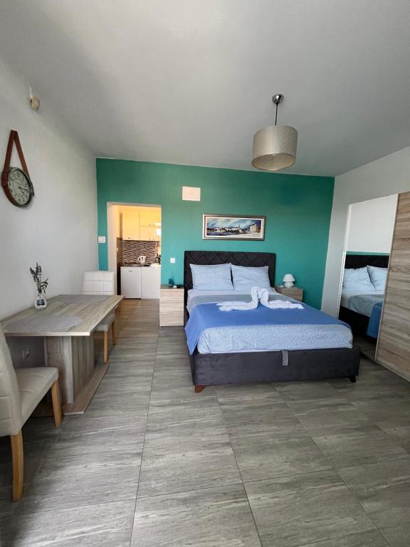 a bedroom with a bed and a green wall at Apartments Kristal in Kaštela