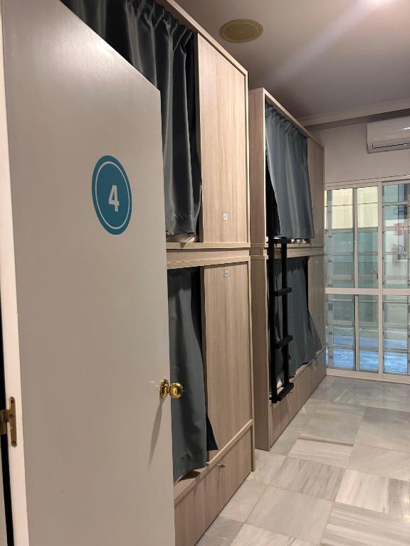 an open door to a room with black curtains at Hostel Sorolla Playa in Málaga