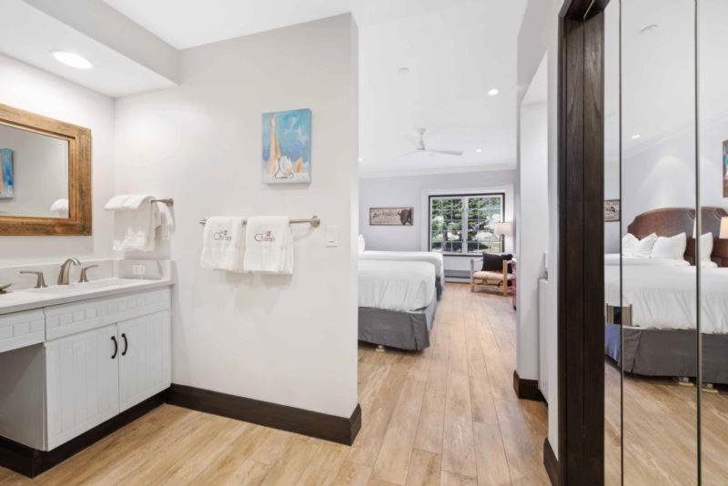 a white bathroom with a bed and a sink at The Charter at Beaver Creek B135 in Beaver Creek