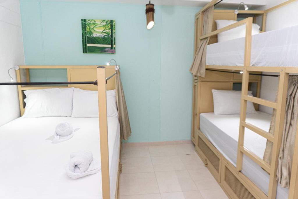 Postel nebo postele na pokoji v ubytování Hostal Las Guaduas