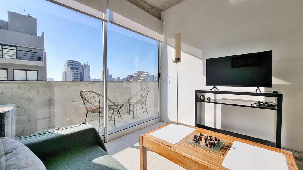 a living room with a couch and a tv at Magico Palermo in Buenos Aires