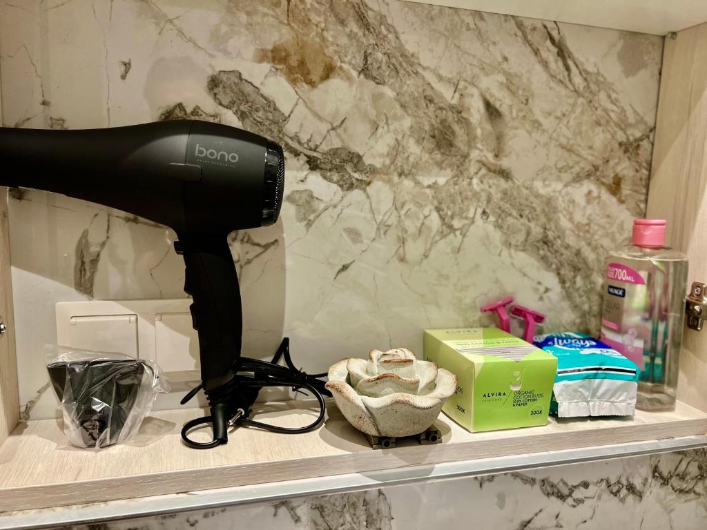 a blow dryer sitting on a shelf in a bathroom at Vienna Charm Apartments Landstraße in Vienna