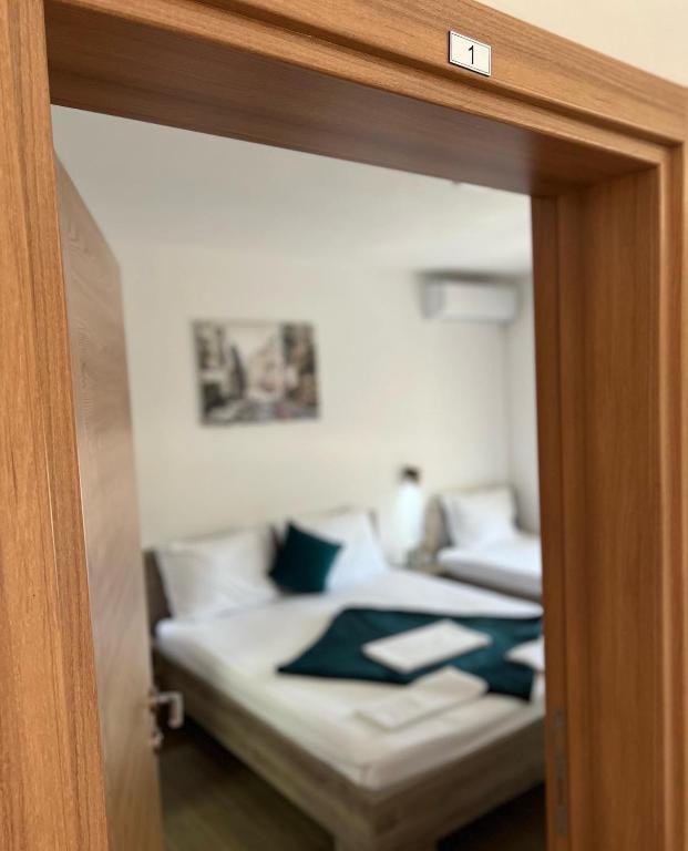 a bedroom with a bed with blue pillows at Apartmani Juković in Ulcinj