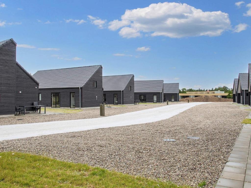 a row of houses on a gravel road at 8 person holiday home in Rømø-By Traum in Kongsmark
