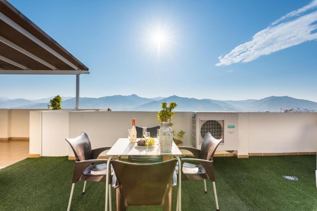 a dining room with a table and chairs with a view at Mirador del Guadalhorce in Alora