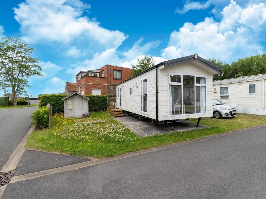 a tiny house sitting on the side of a street at Chalet in De Haan near Sandy Beaches in De Haan