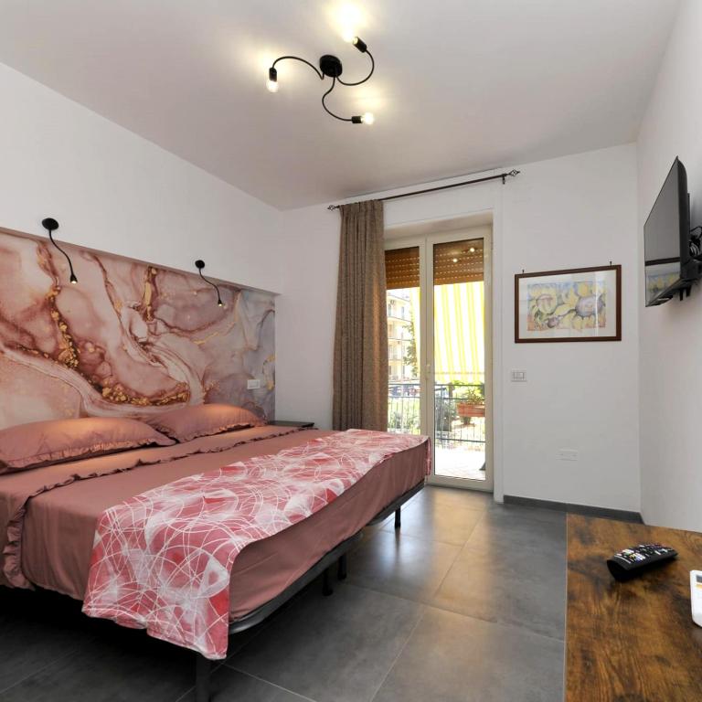 a bedroom with a large bed with a large headboard at MaryGiò in Salerno