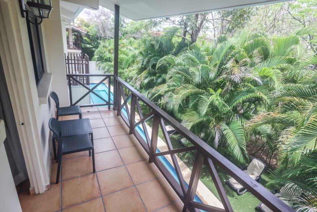 a balcony with a view of a palm tree at Suite Privada en Coronado Luxury Club & Suites in Playa Coronado