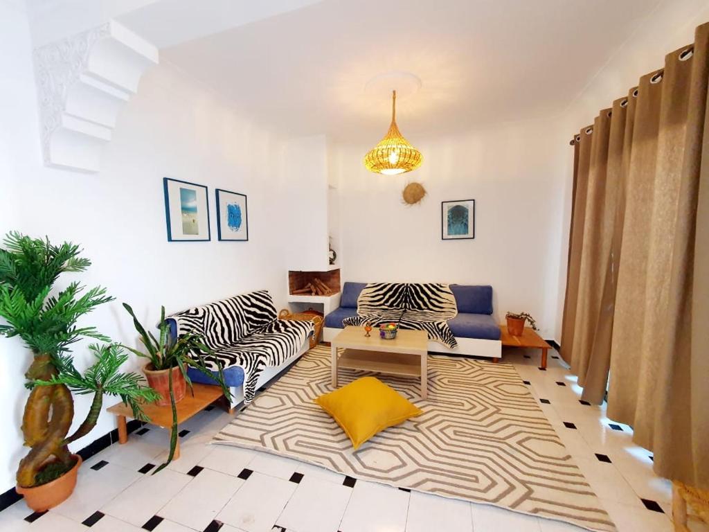 a living room with a zebra patterned rug at Mazighen Art villa in El Jadida