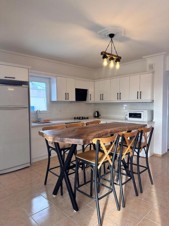 a kitchen with a large wooden table and chairs at Wonderful Sunset 1 in Bodrum City