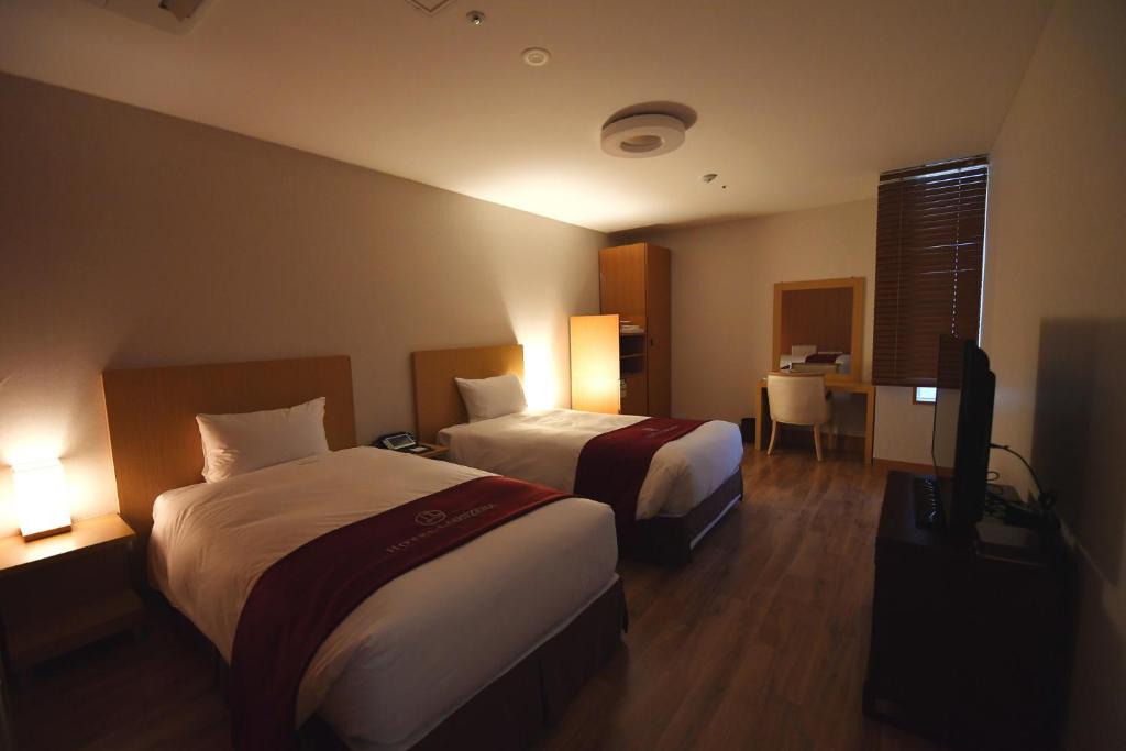 Postel nebo postele na pokoji v ubytování Hotel Laonzena